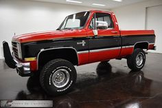 a red and black truck parked in a garage