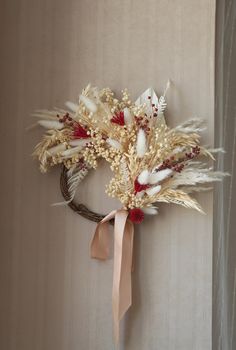 a wreath with feathers hanging on the wall