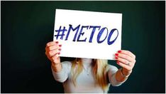 a woman holding up a sign with the word meto written on it in front of her face