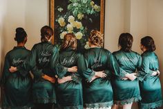 a group of women in green robes standing next to each other with their hands on their hips