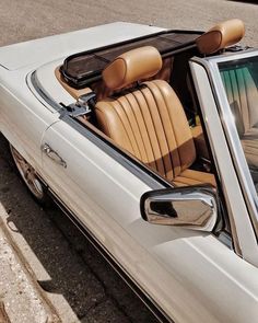 the interior of a white car with tan leather seats