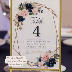 a table number card with flowers on it