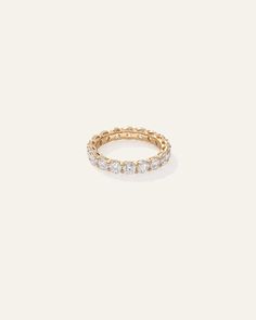 a gold ring with five diamonds on the side, set in 18k yellow gold