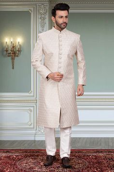 This mens sherwani, style number M42-S143, features a classic design with intricate thread embroidery. This traditional embroidery adds a touch of elegance to the garment, making it perfect for special occasions. The embroidery is done with precision and care, ensuring a high-quality finish for a sophisticated look. Mens Sherwani, Traditional Embroidery, Sophisticated Look, Thread Embroidery, Sherwani, Classic Design, Light Grey, Thread, Embroidery