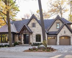 a large house in the woods with lots of trees