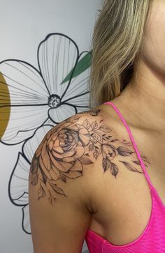 a woman with a flower tattoo on her shoulder