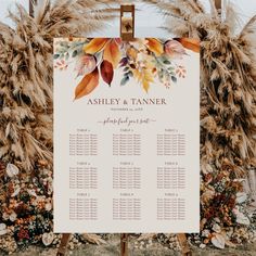 a wedding seating sign with fall leaves on it