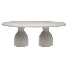 a white table with two grey vases on it's legs and an oval top