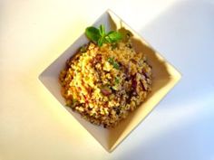 a white bowl filled with food on top of a table