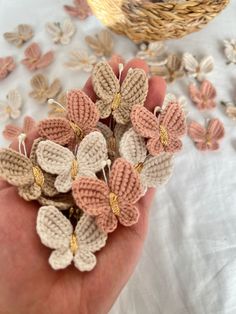 small crocheted flowers are being held in someone's hand