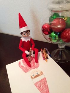 an elf is sitting on top of a card