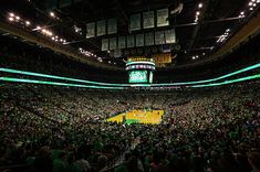 an indoor basketball court with lots of people sitting in the seats and watching it from above