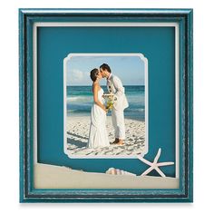 a man and woman kissing on the beach with starfish in front of them,