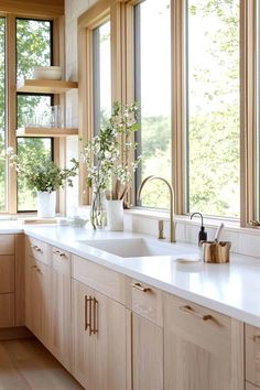 a kitchen filled with lots of windows next to a sink and counter top under a window