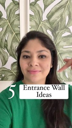 a woman in green shirt pointing at the camera with text overlay that reads, 5 entrance wall ideas