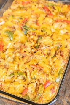 chicken fajita rice - iron casserole in a glass baking dish on a wooden table