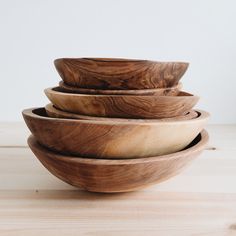 four wooden bowls stacked on top of each other