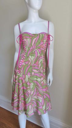 For Sale on 1stDibs - A beautiful fine stretch silk dress in a vibrant pink and green geometric print from Dolce & Gabbana. The bodice is vertically boned and fitted through Fitted Pink Corset Dress For Summer, Pink Square Neck Corset Dress For Summer, Pink Summer Dresses With Boned Bodice, Summer Silk Corset Dress With Boned Bodice, Silk Corset Dress With Boned Bodice For Summer, Silk Fitted Dress With Tie Straps, Fitted Silk Dresses With Tie Straps, Pink Fitted Dress With Lined Bodice, Pink Summer Dress With Boning