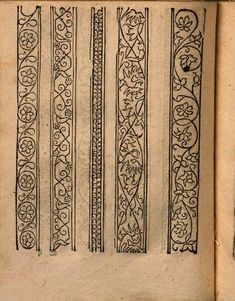 an old book with decorative designs on the cover and pages lined up in two rows