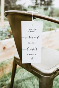 a sign that says reserved for the mother of the bride on a chair with flowers