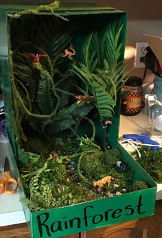 an open box filled with plants on top of a counter