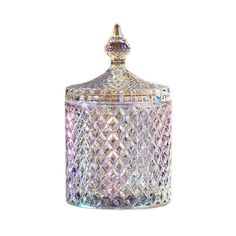 a clear glass jar with a diamond design on the top and bottom, is shown in front of a white background