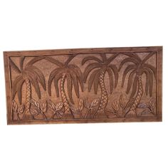 a wooden panel with palm trees and leaves on the bottom, along with other tropical plants