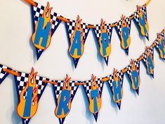 this is a photo of a birthday banner with cars hanging from it's sides