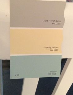 several shades of gray, yellow and blue are on the wall in this room that is painted