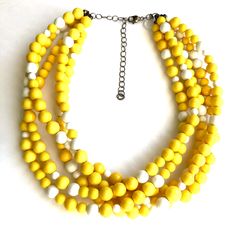 Bright sunny yellow meets pops of white in this 5 strand statement necklace full of lightweight vintage lucite beads. This style is known as the Sylvie Necklace. Beads are opaque shiny & matte mixed finish in that great retro look & they were made in the 1960's. Necklace measures 15.5-16" at it's shortest + a 6" extender. Lightweight and fun to wear: a classic style that will outlast trends. Jewelry is hand finished & designed here in the US. Most all jewelry parts are salvaged as le Yellow Necklace, Yellow Jewelry, Vintage Lucite, Costume Jewelry Necklaces, Gold Plated Necklace, Fantasy Jewelry, White Beads, Fun Earrings, Multi Strand