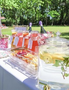 there are many drinks on the table and in glass jars with labels that say it's summer