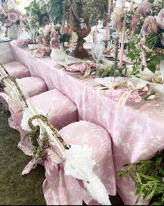 the table is covered with pink and white florals for an elegant dinner or bridal party