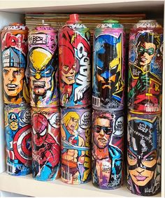 many different colored cans are on display in a shelf with one has an image of the avengers and captain america