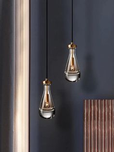 three light fixtures hanging from the ceiling in a room