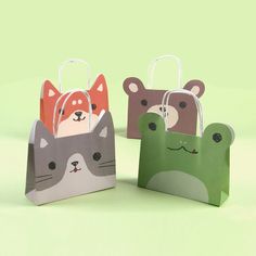 three small bags with animals on them, one is green and the other is brown