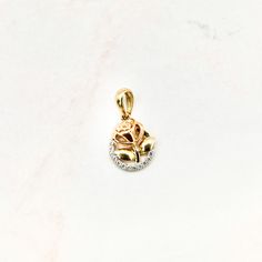 A 14k rose pendant features an intricate design crafted from 14 karat gold, incorporating two distinct colors – yellow and rose gold. The pendant showcases a rose motif, symbolizing beauty and love, with the two-tone combination enhancing its visual appeal. The piece is likely to be delicate yet stylish, making it a versatile and charming accessory. 14k solid yellow gold 3.5mm tall excluding bail x 2mm wide Chain is not included White cubic zirconia stones Product color may differ due to lightin Rose Motif, Rose Pendant, Intricate Design, A Rose, Solid Yellow, Yellow Color, Design Crafts, Online Jewelry, Gold Pendant