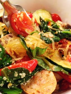 a white bowl filled with lots of food and a fork sticking out of the side