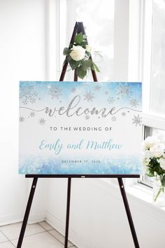 a welcome sign sitting on top of a wooden easel in front of a window