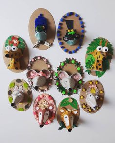 a group of animal heads are arranged on wooden plates with holes in the shape of animals