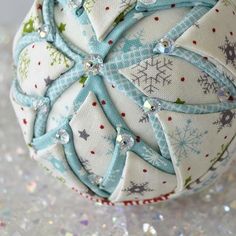 an ornament with snowflakes on it sitting on top of a table