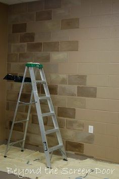 a ladder sitting on top of a wooden floor in front of a wall with bricks