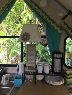 a kitchen area with a sink, stove and window in the back drop off room