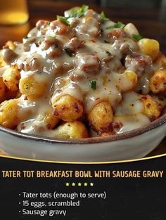 a bowl filled with tater tots covered in gravy on top of a table