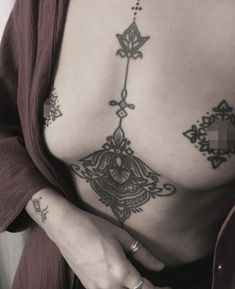 a woman with tattoos on her stomach