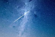 an airplane is flying in the sky with stars