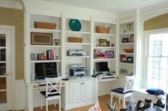 a living room filled with lots of furniture and bookshelves next to a window