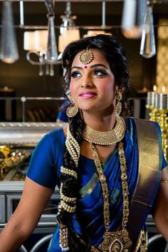 a woman in a blue sari with gold jewelry