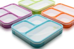 four different colored plastic containers with dividers on each side and one empty container in the middle