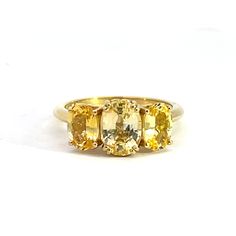 An 18k yellow gold 3 stone ring featuring one double prong set natural/untreated Sri Lankan oval faceted yellow sapphire 1.79 carats and 2 prong set Sri Lankan oval faceted yellow sapphires 1.92 total carat weight- 3.71 carats of yellow sapphire in the ring. This ring was custom designed and made by Sydney Strong. Oval Yellow Sapphire Jewelry With Accent Stones, Yellow Sapphire Gemstone Jewelry, Elegant Yellow Sapphire Round Jewelry, Classic Round Yellow Sapphire Jewelry, Oval Yellow Sapphire Jewelry With Polished Finish, Round Yellow Sapphire Gemstone Jewelry, Yellow Sapphire Ring, 3 Stone Ring, Yellow Sapphire Rings