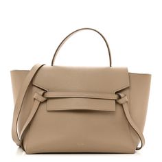 This is an authentic CELINE Grained Calfskin Mini Belt Bag in Light Taupe. This chic tote is crafted of drummed calfskin leather with a structured and spacious silhouette in light beige. The bag features a leather strap top handle, an optional shoulder strap, a back zipper compartment, and a front-facing flap that is secured by decorative knotted straps. The facing flap opens to a suede interior with hanging leather patch pockets. Beige Pebbled Leather Top-handle Satchel, Beige Pebbled Leather Top Handle Satchel, Elegant Taupe Shoulder Bag With Smooth Grain, Taupe Calf Leather Bag With Top Handle, Taupe Calf Leather Top Handle Bag, Taupe Top Handle Bag In Calf Leather, Classic Taupe Calf Leather Bag, Timeless Beige Calf Leather Satchel, Timeless Beige Epsom Leather Bag